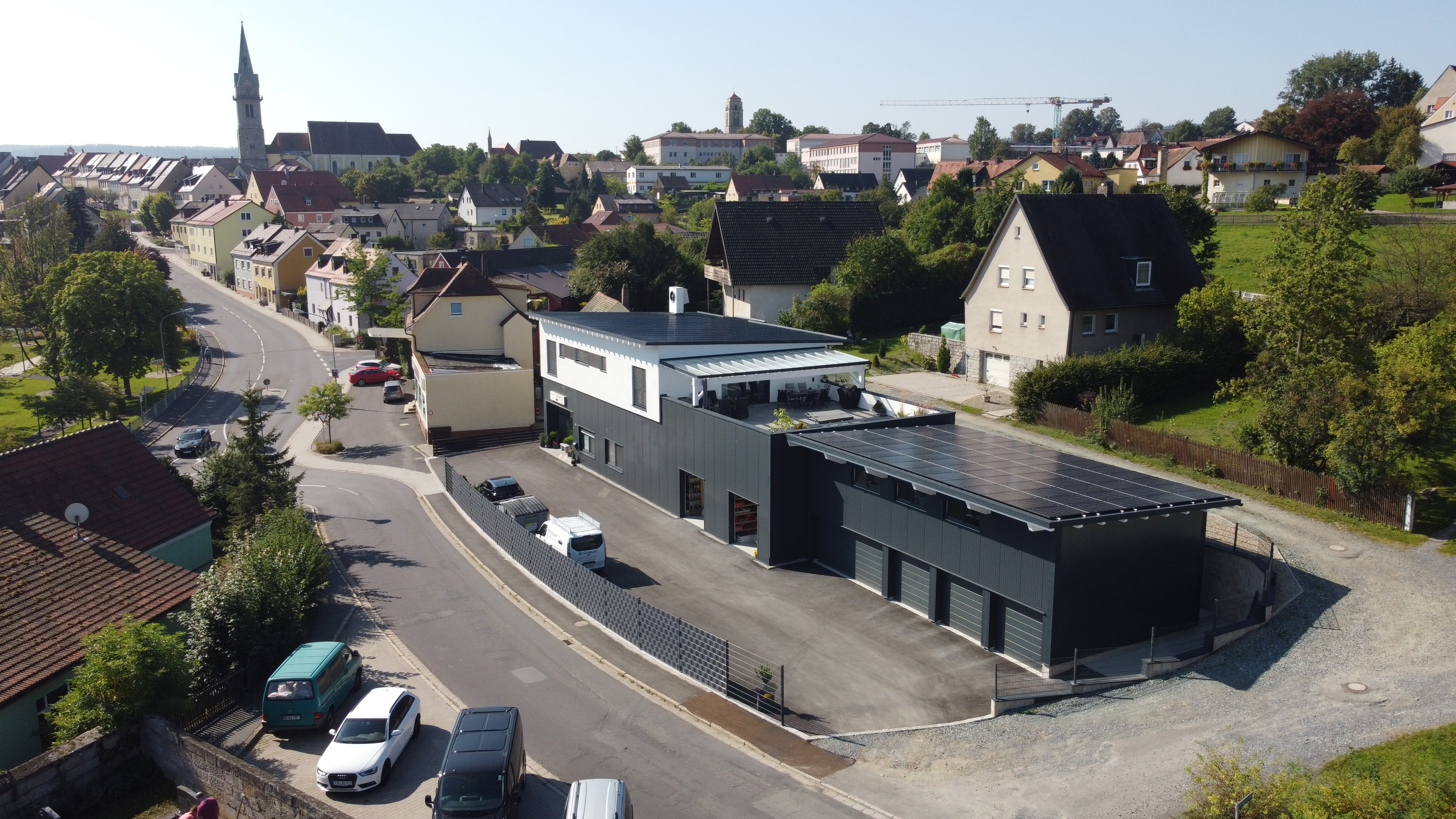 Luftaufnahme des Firmengebäudes von Grünauer Heizung Sanitär mit Photovoltaikanlage.